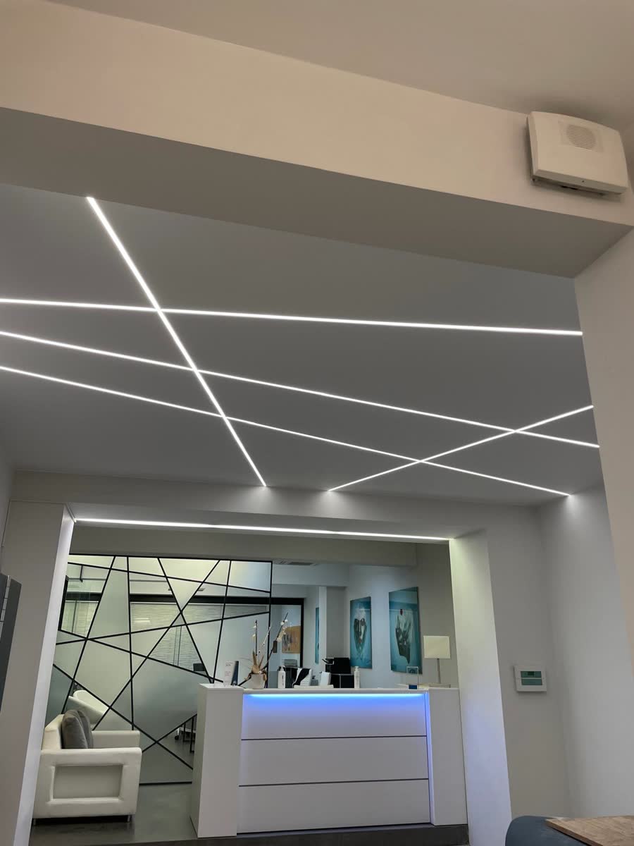 Éclairage LED linéaire encastré au plafond d'un hall d'accueil de bureaux au Luxembourg